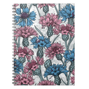 Pink and blue cornflowers, wild flowers on white notebook