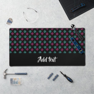 Pink and blue decorative print on black desk mat