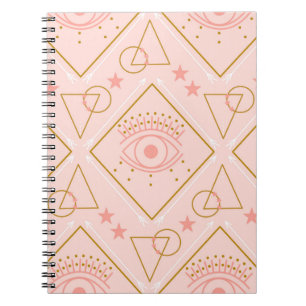 Pink and gold eyes and geometric elements in a sea notebook