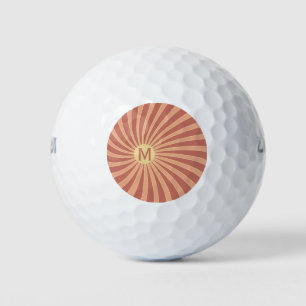 Pink and orange retro style sunburst design golf balls