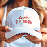 Pink and Red The Bride Bridal Party Personalised Embroidered Hat<br><div class="desc">Red script name with a pink description of "The Bride" embroidered baseball hat cap.</div>