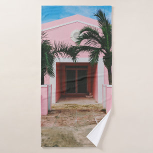 PINK AND WHITE CONCRETE HOUSE NEAR GREEN TREES UND BATH TOWEL