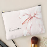 Pink Bow Bridesmaid Gift Accessory Pouch<br><div class="desc">This is a stylish and elegant personalised makeup pouch featuring a soft pink background adorned with a large, delicate pink ribbon bow. The design exudes a feminine and sophisticated charm, perfect for carrying your essential cosmetics and beauty items. The pouch can be customised with a name, making it a unique...</div>