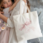 Pink Bow Tote Bag<br><div class="desc">Add a touch of elegance and femininity to your everyday style with this chic tote bag featuring a delicate pink bow and a personalised script initial monogram. The soft, girly design is perfect for a stylish accessory, adding a cute and trendy accent to any outfit. Easily customise with your initial...</div>