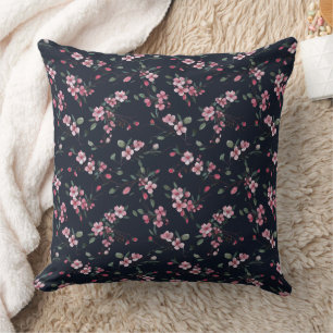 Pink cherry blossoms on a navy blue pattern cushion
