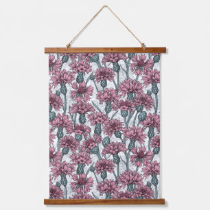 Pink cornflowers, wild flowers on white hanging tapestry