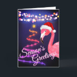 Pink Flamingo Festive Tropical Beach Christmas Holiday Card<br><div class="desc">This Season's Greetings tropical beach Christmas greeting card features a pink flamingo wearing a red and white Santa hat.  There are festive holiday string lights and a Ribbon and Stars Christmas tree.  Inside Greeting ~ "Warmest Wishes From Our Holiday Paradise To Yours".   ^</div>