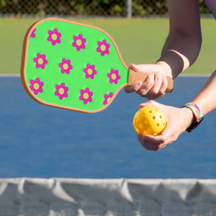 Pink flowers on green pickleball paddle