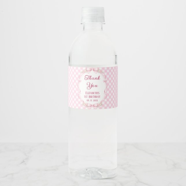 Pink Gingham Bow First Birthday Water Bottle Label (Front)