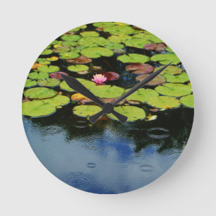 Pink lotus in Rain Round Clock