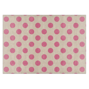 Pink polka dots on cream cutting board