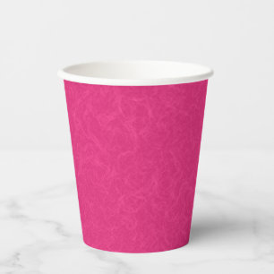 Pink textured surface with subtle swirling pattern paper cups