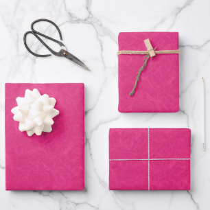 Pink textured surface with subtle swirling pattern wrapping paper sheet