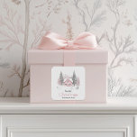 Pink Winter Cottage Christmas Square Sticker<br><div class="desc">This charming Christmas sticker features a soft watercolor illustration of a pink cottage surrounded by snowy evergreens and bare winter trees. The elegant "Merry Christmas" greeting is printed in a delicate serif font, adding a cosy and festive touch. Customisable with a family name, this whimsical sticker is perfect for spreading...</div>