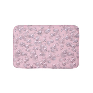 Placers of white-pink pearls on pink velvet bath mat