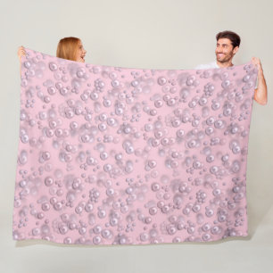 Placers of white-pink pearls on pink velvet fleece blanket