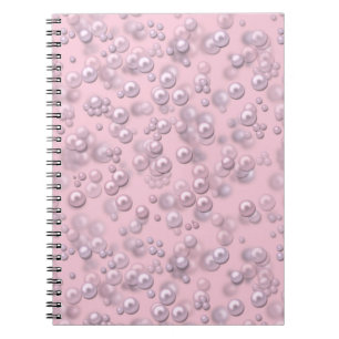 Placers of white-pink pearls on pink velvet notebook