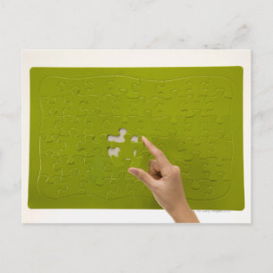 Placing a puzzle piece postcard
