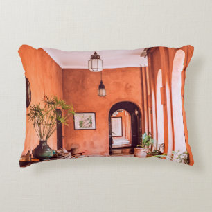 PLANTERS WITH PLANT NEAR AREA RUG INSIDE ROOM DECORATIVE CUSHION