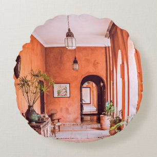 PLANTERS WITH PLANT NEAR AREA RUG INSIDE ROOM ROUND CUSHION