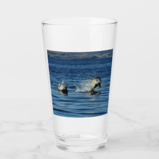 Playful Common Dolphins Porpoising Through Ocean Glass