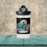 Playful Sea Otters with Child's Name Water Bottle<br><div class="desc">Child's size,  clear plastic water bottle that features the photo image of a couple of Sea Otters playing with a ball toy along with a child's name printed in white,  bold letters. Personalise water bottle by editing name and replacing with child's name. Select your water bottle colour.</div>