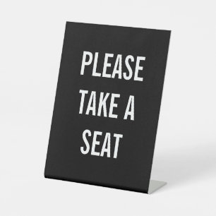 PLEASE TAKE A SEAT PEDESTAL SIGN
