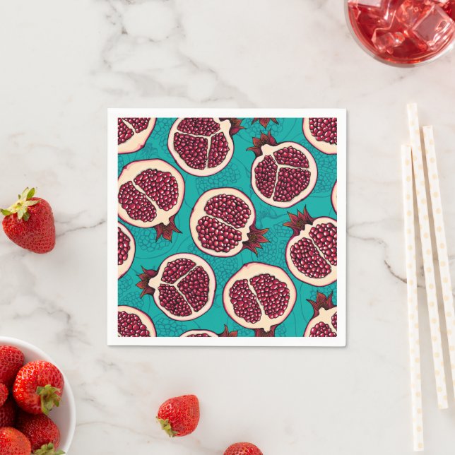 Pomegranate slices on turquoise napkin (Insitu)