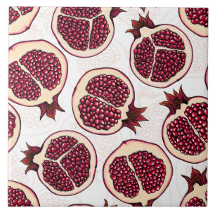 Pomegranate slices on white tile