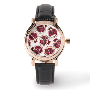Pomegranate slices on white watch