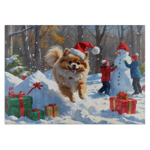 Pomeranian Running in Snow with Christmas Hat Cutting Board