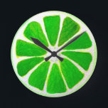 Pop art bright lime fruit original watercolour round clock<br><div class="desc">A cute and colorful vibrant green lime fruit slice from an original painting by artist Sacha Grossel. This large pop art style fruit is green and very bright and colorful against a customizable orange colored background. Quirky and original.</div>
