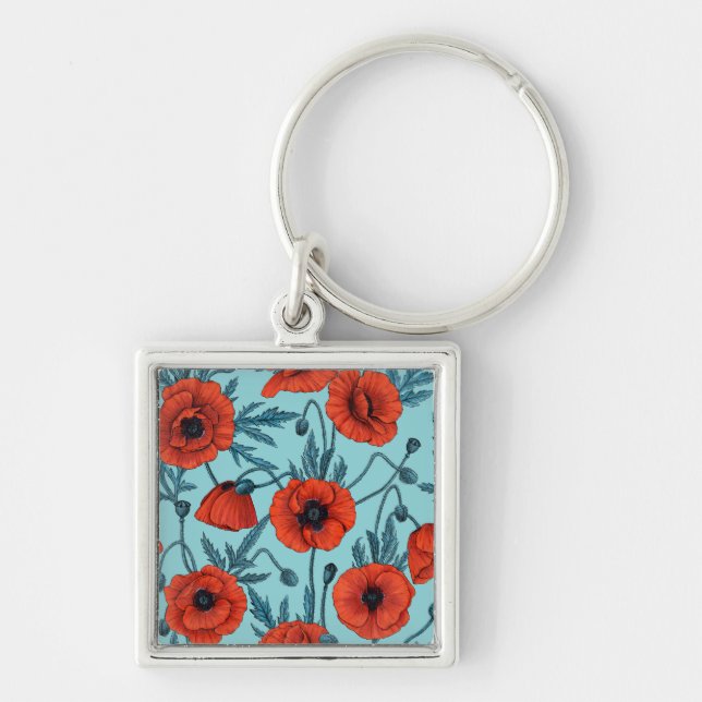Poppies, red and blue on pool blue key ring (Front)