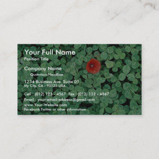 Poppy head amongst clover business card