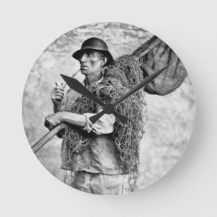 Portrait of a Fisherman Carrying his Nets (b/w pho Round Clock