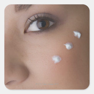 Portrait of a young woman with cream on her square sticker