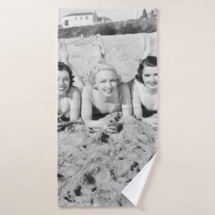 Portrait of five young women lying on the beach an bath towel