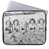 Portrait of five young women lying on the beach an