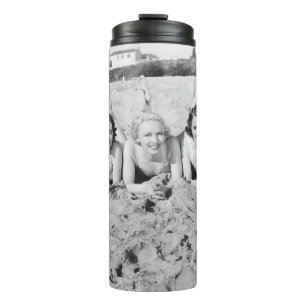 Portrait of five young women lying on the beach an thermal tumbler