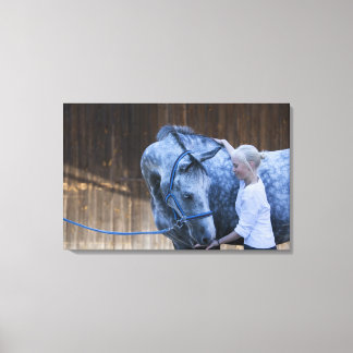 portrait of young girl holding white horse canvas print