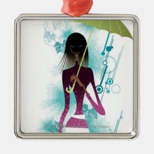 Portrait of young woman holding purse and umbrella metal tree decoration