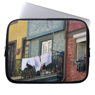 Portugal, Oporto (Porto). Woman hanging laundry Laptop Sleeve