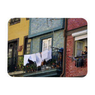 Portugal, Oporto (Porto). Woman hanging laundry Magnet