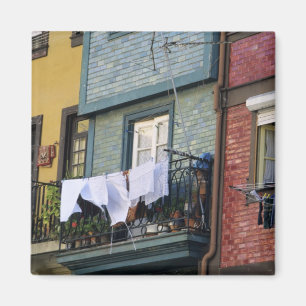 Portugal, Oporto (Porto). Woman hanging laundry Magnet
