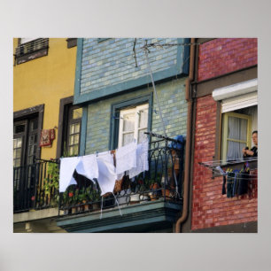 Portugal, Oporto (Porto). Woman hanging laundry Poster