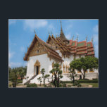 Postcard of a scenic temple in Thailand<br><div class="desc">Photo of a dazzling white temple under a blue sky. The temple,  in the heart of Thailand,  has gold trimmings and traditional Thai architecture  It is surrounded by trees. Stairs lead to one of the entrances. The roof is red and Thai art adorns the outside of the temple.</div>