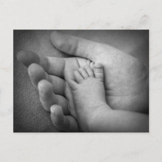 Postcard of baby's foot in mothers hand.
