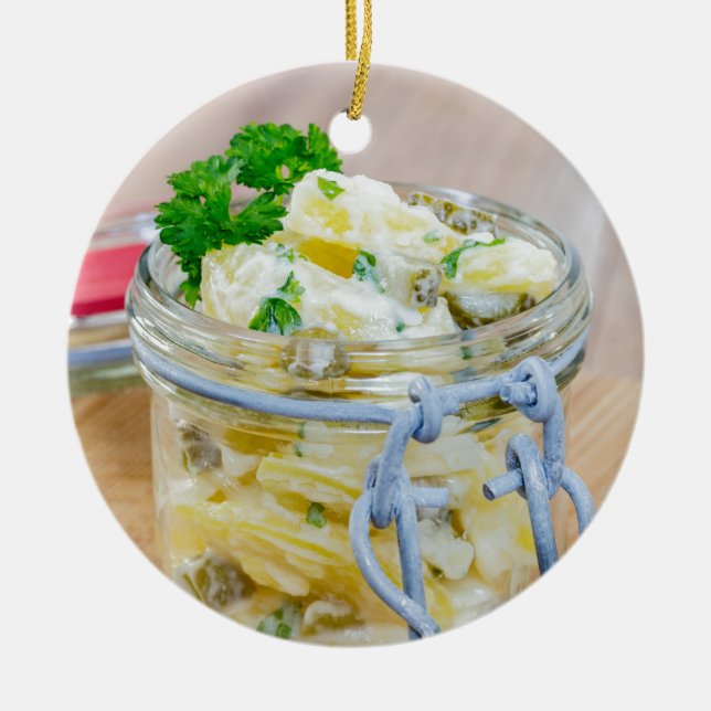 Potato salad in a jar on wooden ceramic tree decoration (Front)