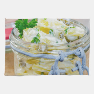 Potato salad in a jar on wooden tea towel