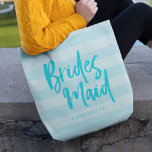 Preppy Blue Stripes Brush Script Bridesmaid Tote Bag<br><div class="desc">Personalised Bridesmaid tote bag featuring the word "Bridesmaid" in trendy brush script against a preppy blue stripes background that's perfect for your bridesmaid to carry her items. Check out the matching makeup bag here https://www.zazzle.com/preppy_blue_stripes_brush_script_bridesmaid_makeup_bag-223509437047049384?rf=238364477188679314 Personalise it by replacing the placeholder text. For more options such as to change the font...</div>